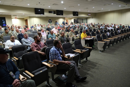  photo of large classroom filled with civilians and military members sitting in chairs
