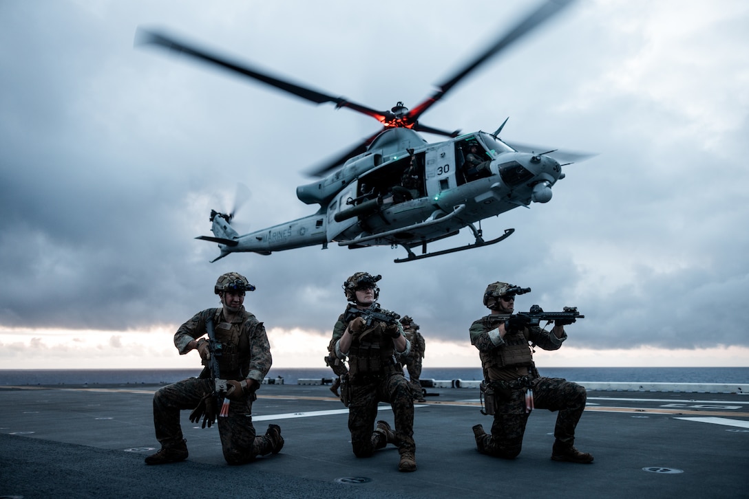 U.S. Marines with the Maritime Special Purpose Force, 26th Marine Expeditionary Unit (Special Operations Capable) (MEU(SOC)), set security while conducting a fast-rope insertion from a UH-1Y Venom during a visit, board, search, and seizure training continuum aboard the Wasp-class amphibious assault ship USS Bataan (LHD 5), Atlantic Ocean, July 19, 2023. Fast-roping is a tactical maneuver used to quickly insert troops into austere terrain in which a helicopter may not be able to land. The 26th MEU(SOC), embarked with the Bataan Amphibious Ready Group, is on a scheduled deployment and remains ready to act as the Nation’s Immediate Response Force within the Fifth and Sixth Fleet’s areas of responsibility. (U.S. Marine Corps photo by Cpl. Kyle Jia)