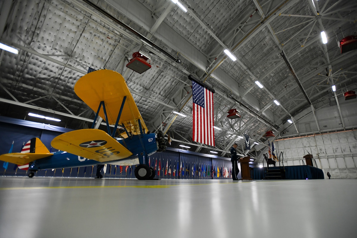 A PT-17 Stearman aircraft sits in Hangar 3 during the Tuskegee Airmen PT-17 Aircraft Exchange ceremony at Joint Base Andrews, Md., July 26, 2023. This aircraft will be put into the National Museum of the U.S. Air Force inventory and displayed at Wright-Patterson Air Force Base, Ohio. (U.S. Air Force photo by Senior Airman Bridgitte Taylor)
