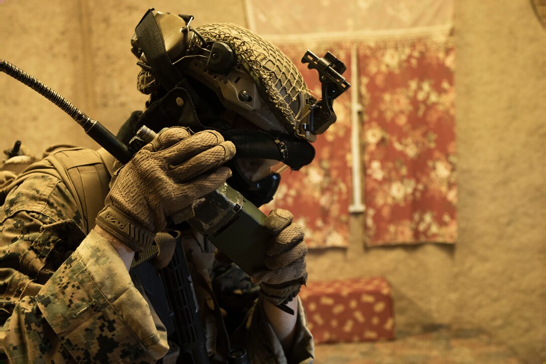 A U.S. Marine with Advanced Infantry Training Battalion, School of Infantry-West, Hawaii Detachment, establishes communications with the command operations  during urban operations training, Marine Corps Training Area Bellows, July 11, 2023. The training was conducted as part of the Advanced Infantry Marine Course. AIMC is designed to enhance and test Marines’ skills with a focus on reinforcing proper patrols and operational procedures. (U.S. Marine Corps photo by Cpl. Chandler Stacy)