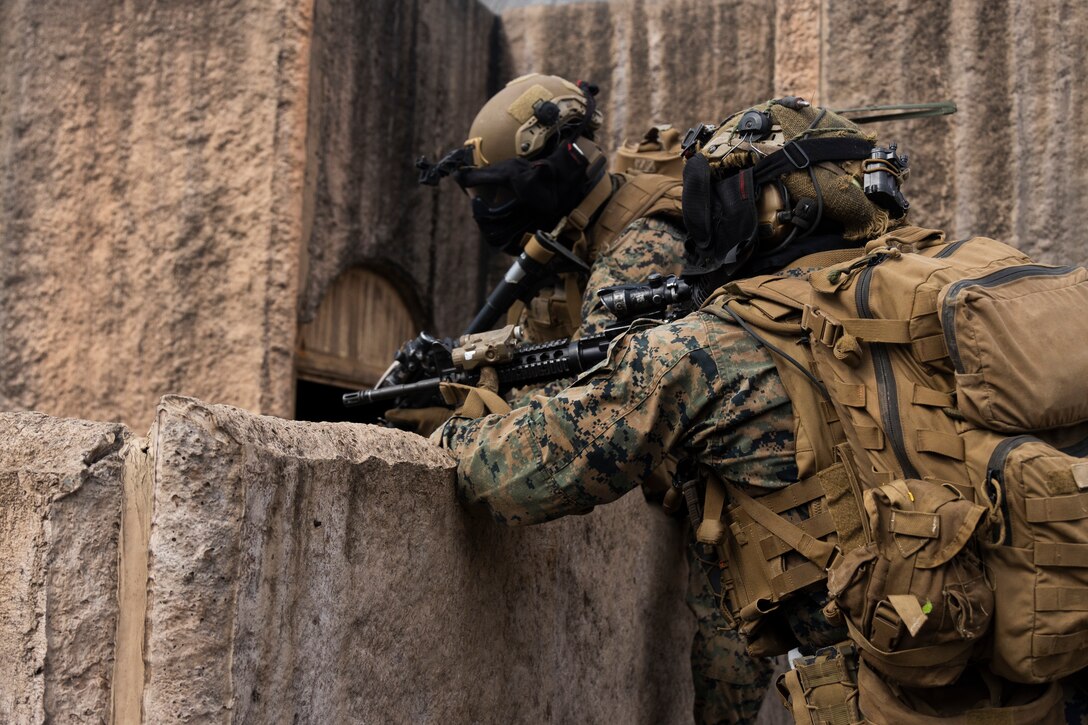 U.S. Marines with Advanced Infantry Training Battalion, School of Infantry-West, Hawaii Detachment, advance towards an objective  during urban operations training, Marine Corps Training Area Bellows, July 11, 2023. The training was conducted as part of the Advanced Infantry Marine Course. AIMC is designed to enhance and test Marines’ skills with a focus on reinforcing proper patrols and operational procedures. (U.S. Marine Corps photo by Cpl. Chandler Stacy)