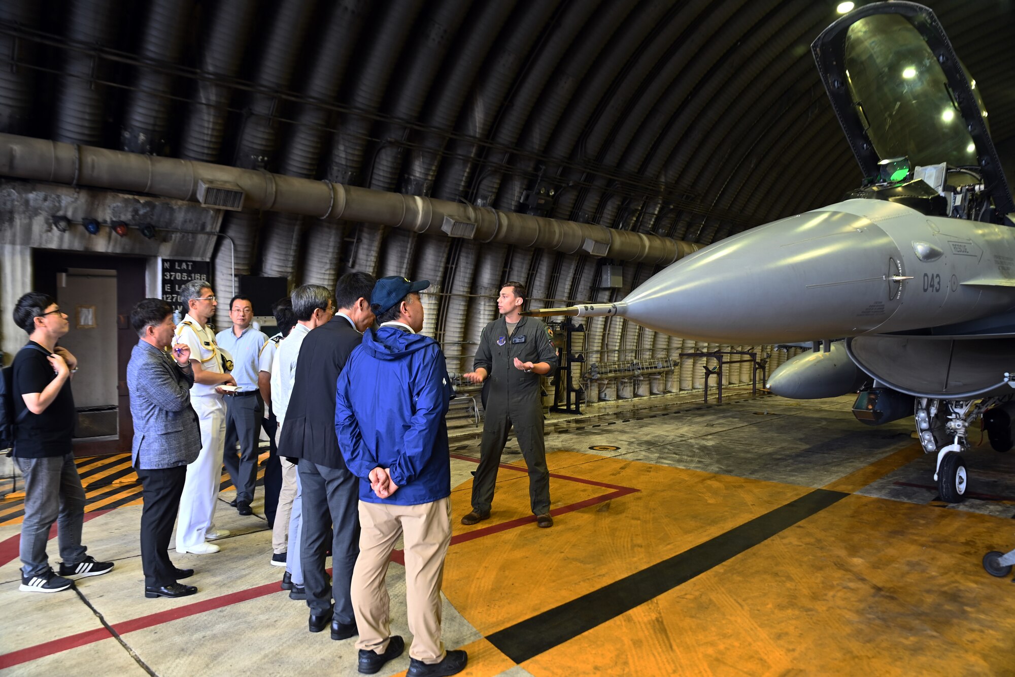 U.S. Air Force Capt. Jonathan Kline, right, 35th Fighter Squadron, briefs members of the Research Institute for Indo-Pacific Affairs during a visit to Osan Air Base, Republic of Korea, July 18, 2023.