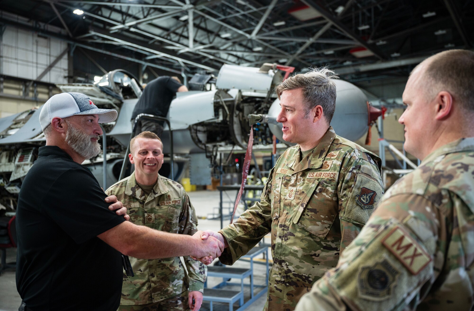Chief Master Sgt. Jeremiah W. Ross 7th Air Force command chief, shakes hands with Forest Holliman during his visit at Kunsan Air Base