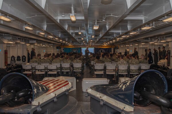 Midshipmen listen to Rear Adm. John Meier