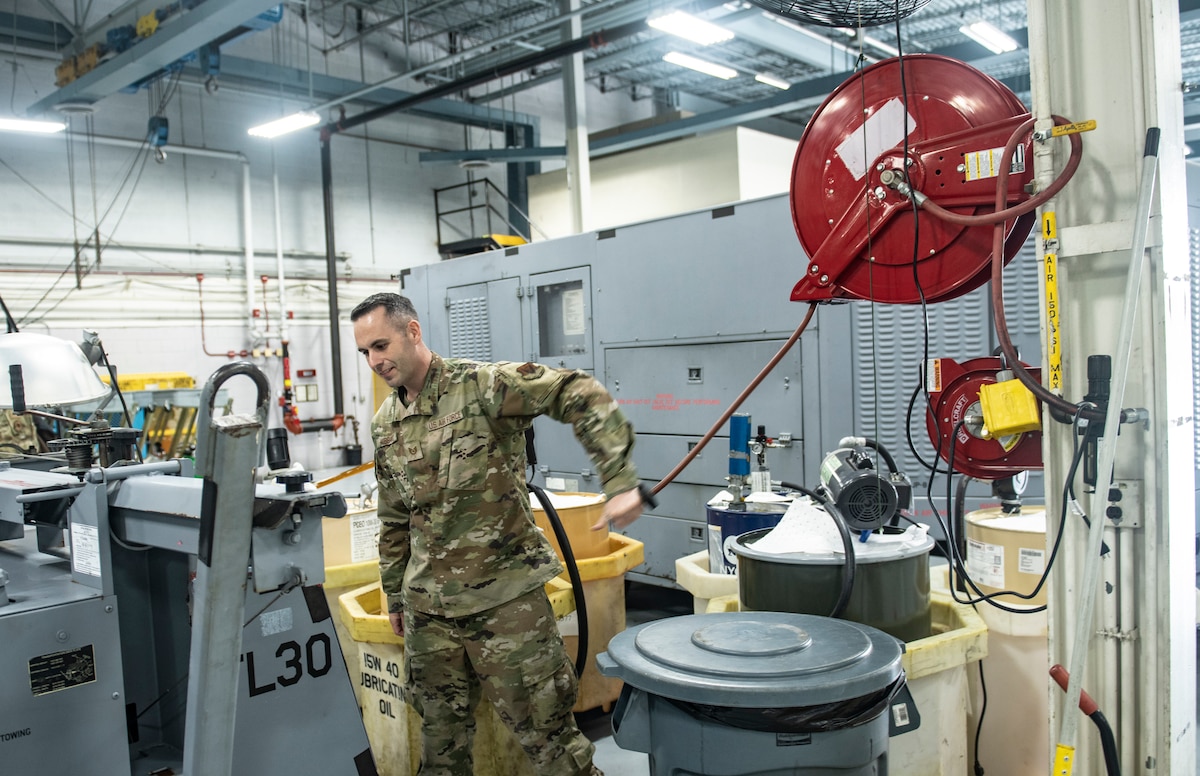 Man in camouflage uniform uses machine