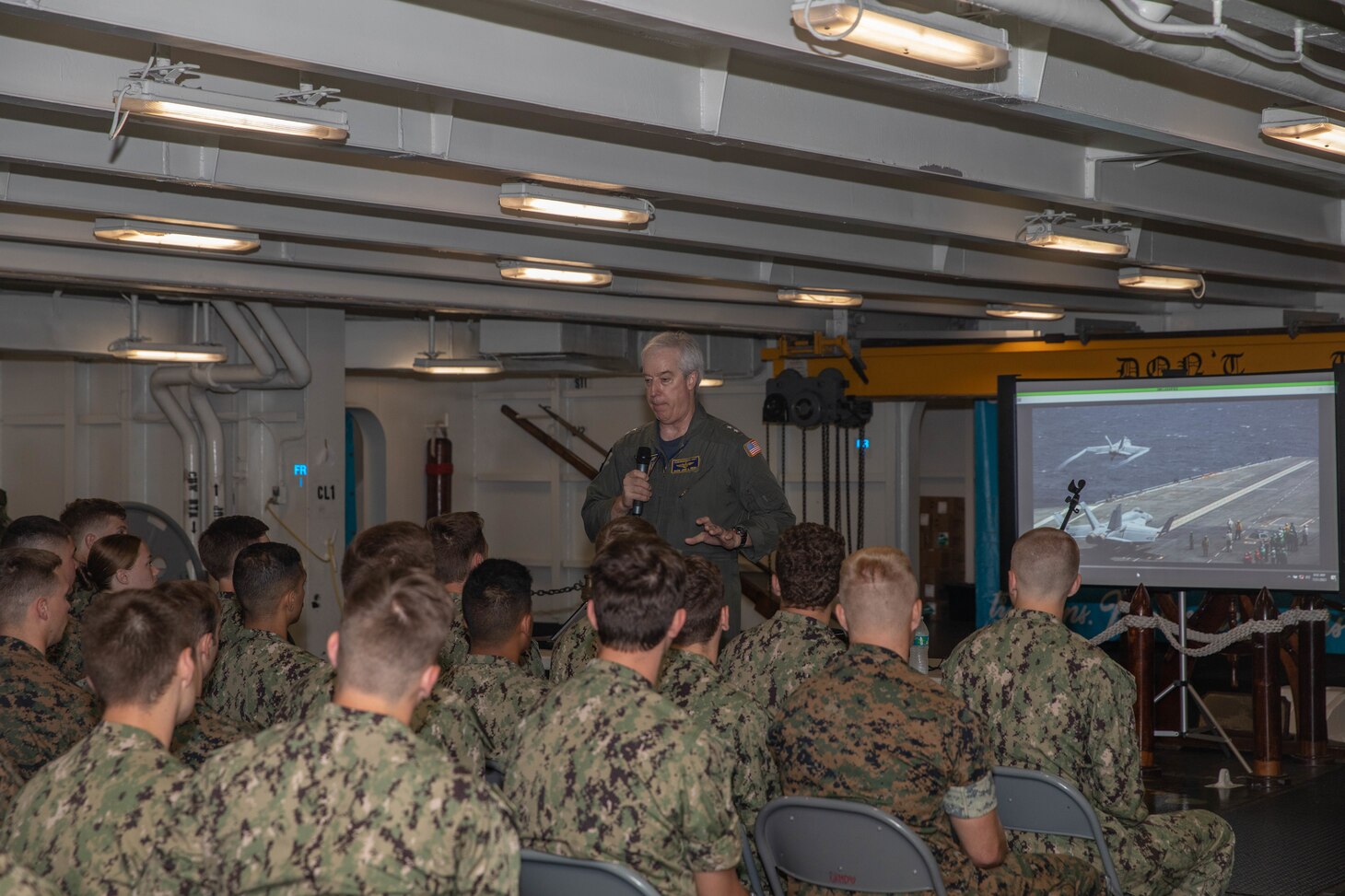 Midshipmen listen to Rear Adm. John Meier