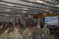 Midshipmen listen to Rear Adm. John Meier