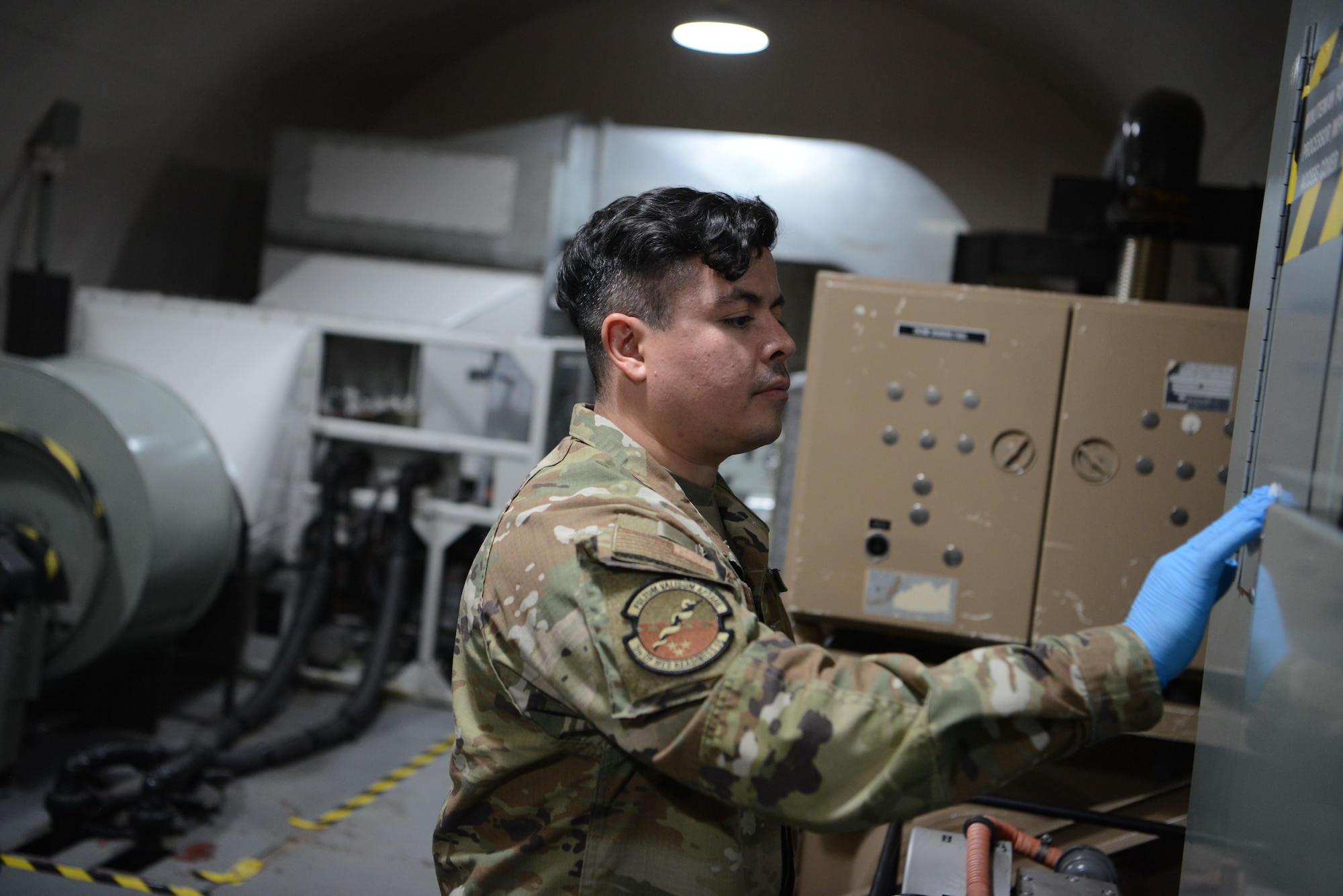 U.S. Air Force Staff Sgt. Oscar Ruiz-Camacho, a 5th Operational Medical Readiness Squadron bioenvironmental engineering technician, swabs to collect data for a swipe sample at a missile alert facility (MAF), near Minot Air Force Base, North Dakota, July 25, 2023. Ruiz-Camacho collected a swipe sample to test for presence of polychlorinated biphenyls. Airmen from the 5th OMRS conducted these tests as part of the ongoing “Missile Community Cancer Study,” air, water and soil quality will be tested at all the missile alert facilities within Air Force Global Strike Command’s three operational intercontinental ballistic missile wings for potential occupational hazards. USAFSAM is part of the Air Force Research Laboratory’s 711th Human Performance Wing.