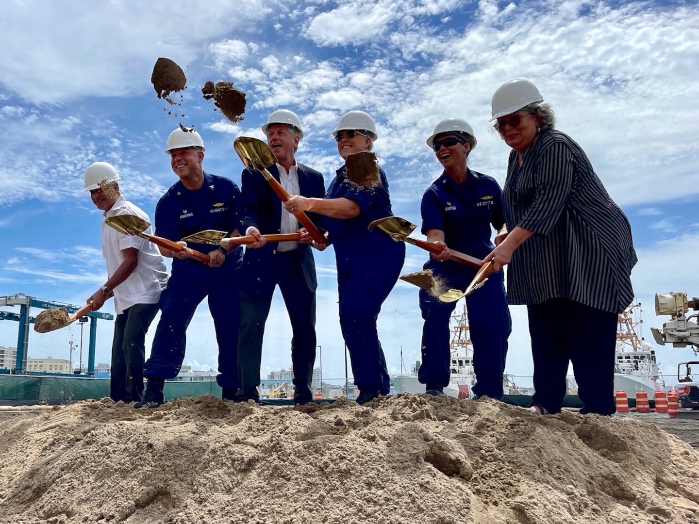 (From left) Mr. Feliz Lizasuain Martinez, Puerto Rico Deputy State Secretary, Capt. Neal Armstrong, Commanding Officer Facilities Design and Construction Center (FDCC), Mr. Brian Labbe, Senior Vice President Operations, Tutor Perini Corporation, Rear Adm. Carola List, Director of Operational Logistics (DOL), Cmdr. Dianna Garfield, Commanding Officer Base San Juan and Ms. Gloria Ortiz, Deputy Puerto Rico State Historic Preservation Office celebrate the groundbreaking for rebuild efforts focused on Coast Guard infrastructure impacted by Hurricane Maria, July 27, 2023. New construction includes a 40,000 square-foot multi-mission building, a 5,000 square-foot base facilities building, front gate entrance, shoreline armored revetment, and a boat ramp. (U.S. Coast Guard photo.)