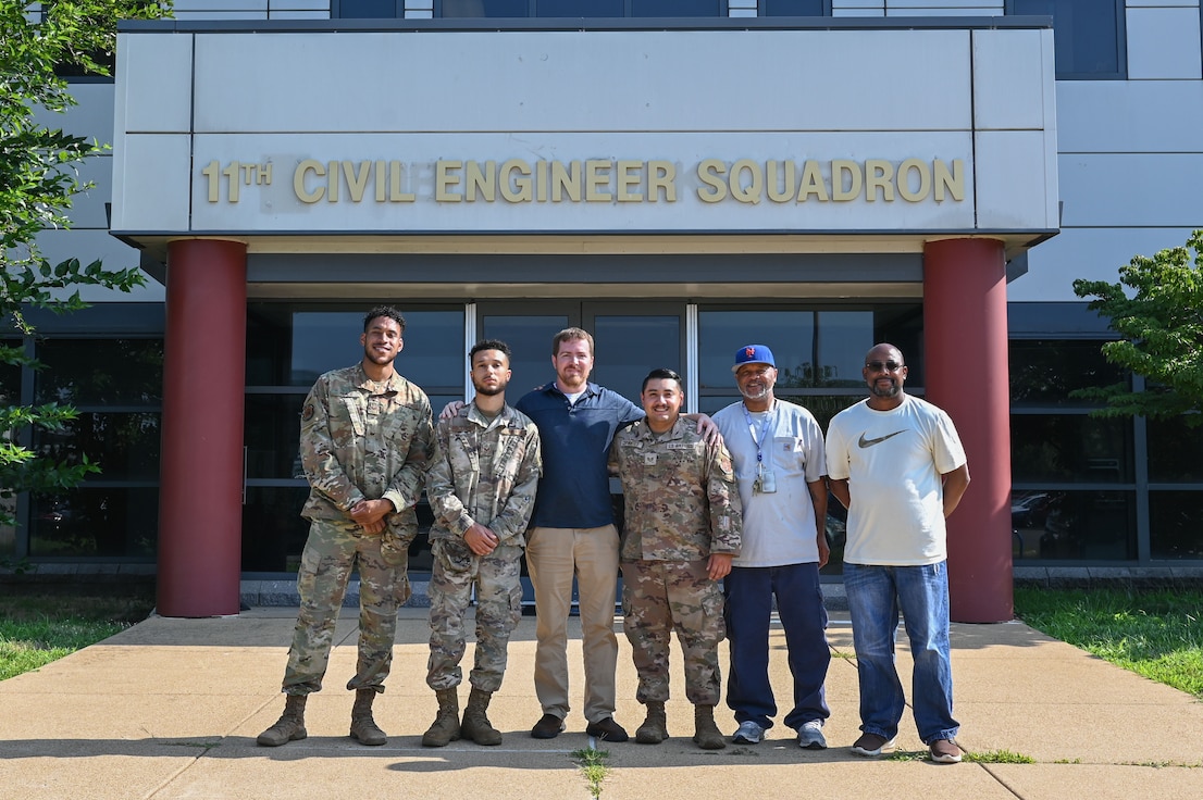 Members of the 11th Civil Engineer Squadron pause for a photo after restoring power on Joint Base Anacostia-Bolling, Washington, D.C., July 28, 2023. Comprised of Airmen (Active Duty and District of Columbia Air National Guard) and several civilian employees, the team worked more than 20 continuous hours July 24-25, 2023, restoring power to multiple base entities and residences after an unexpected power outage. In addition to the team pictured, nearly 20 Airmen from the 11th CES, 316th CES and civilian contractors played key roles in power restoration. (U.S. Air Force photo by Senior Airman Anna Smith)