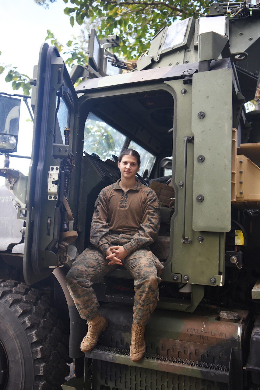 A Marine sits in a truck.