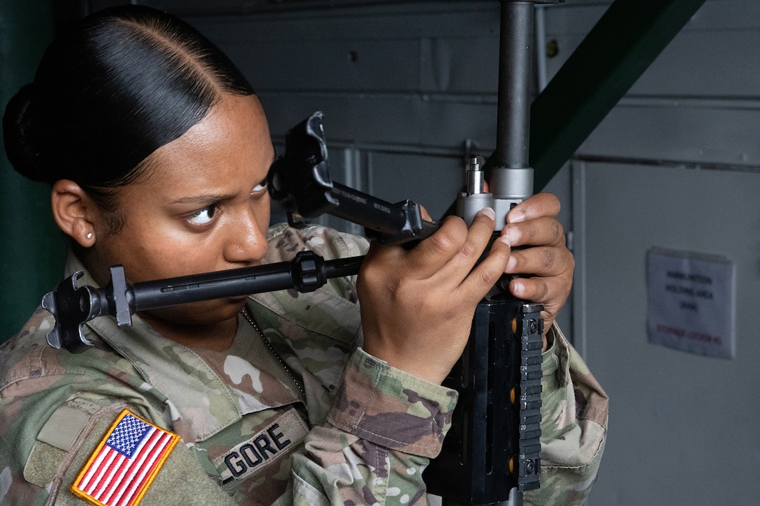 A soldier inspects a weapon.