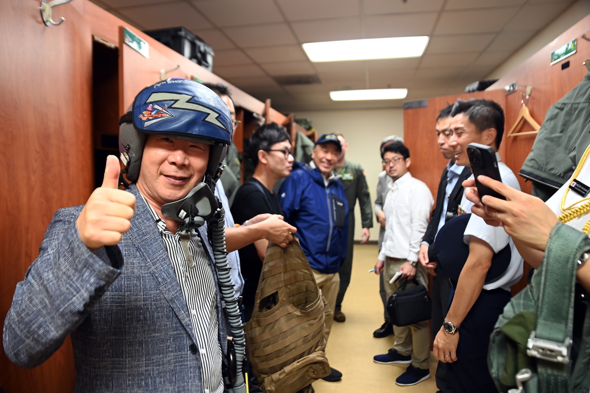 Members of the Research Institute for Indo-Pacific Affairs try on aircrew flight equipment during a visit to Osan Air Base, Republic of Korea, July 18, 2023.