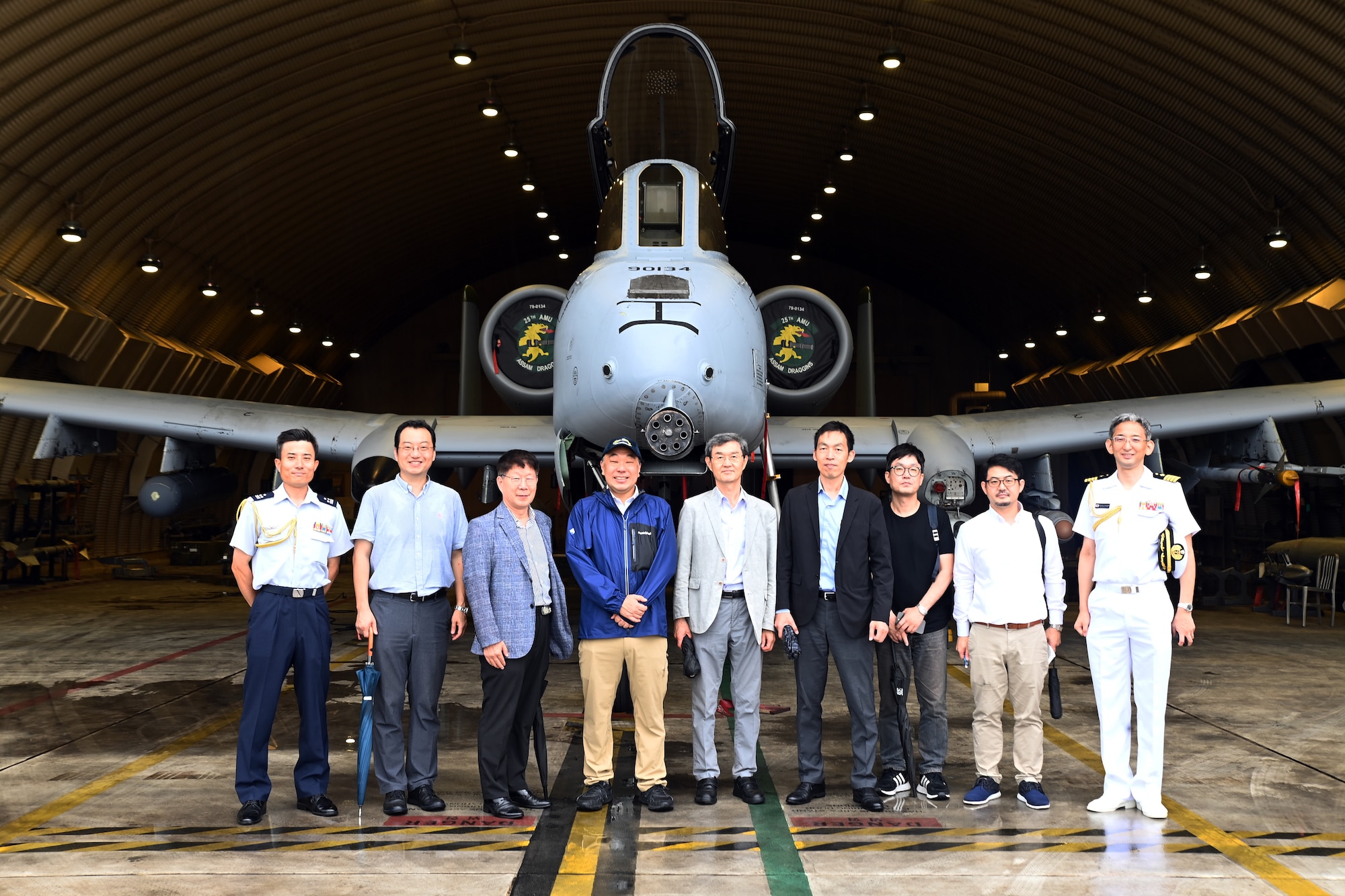 Members of the Research Institute for Indo-Pacific Affairs stand for a group photo during a visit to Osan Air Base, Republic of Korea, July 18, 2023.