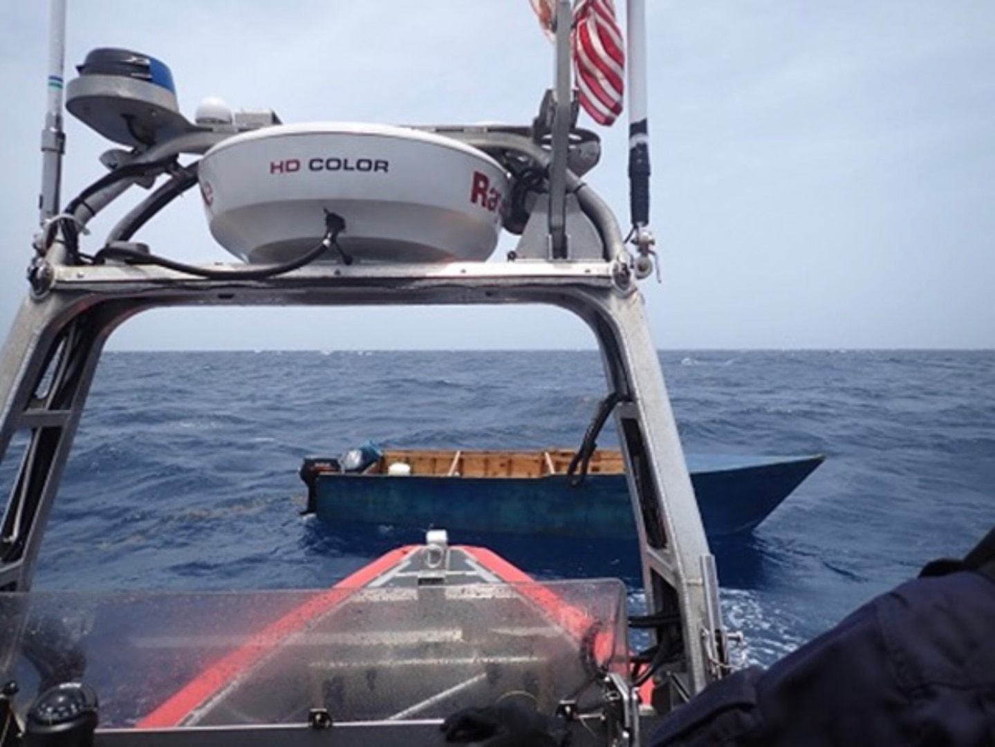 Crewmembers from Coast Guard Cutter Donald Horsley interdict a rustic vessel approximately 8 miles west of Aguadilla, Puerto Rico, July 19, 2023. The 35 people aboard the vessel were repatriated back to Dominican Republic, July 19, 2023. (U.S. Coast Guard photo)