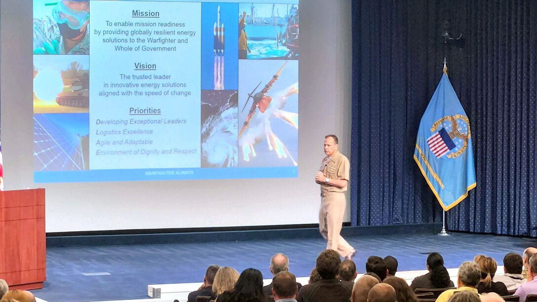 DLA Energy Commander Navy Capt. Brian Anderson on a stage