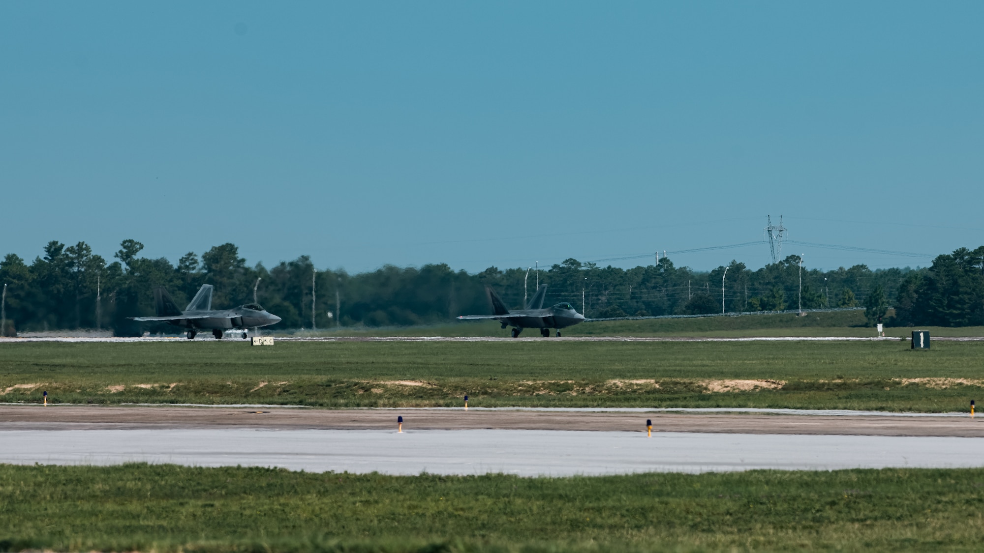 F-22 Raptors prepare to take off.