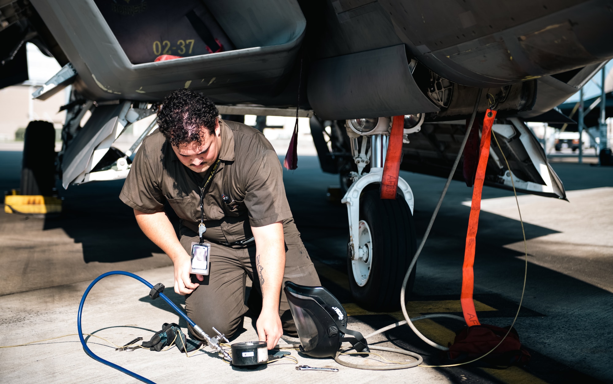 Airman performs aircraft maintenance.