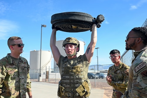 U.S. Air Force Airman 1st Class Luke Strope, 355th Logistics Readiness Squadron fuels lab technician, holds a jet fuel hose over his head for 60 seconds during a forward area refueling point team tryout at Davis-Monthan Air Force Base, Ariz., July 28, 2023. FARP was a specialized team that facilitated aircraft refueling in austere environments.