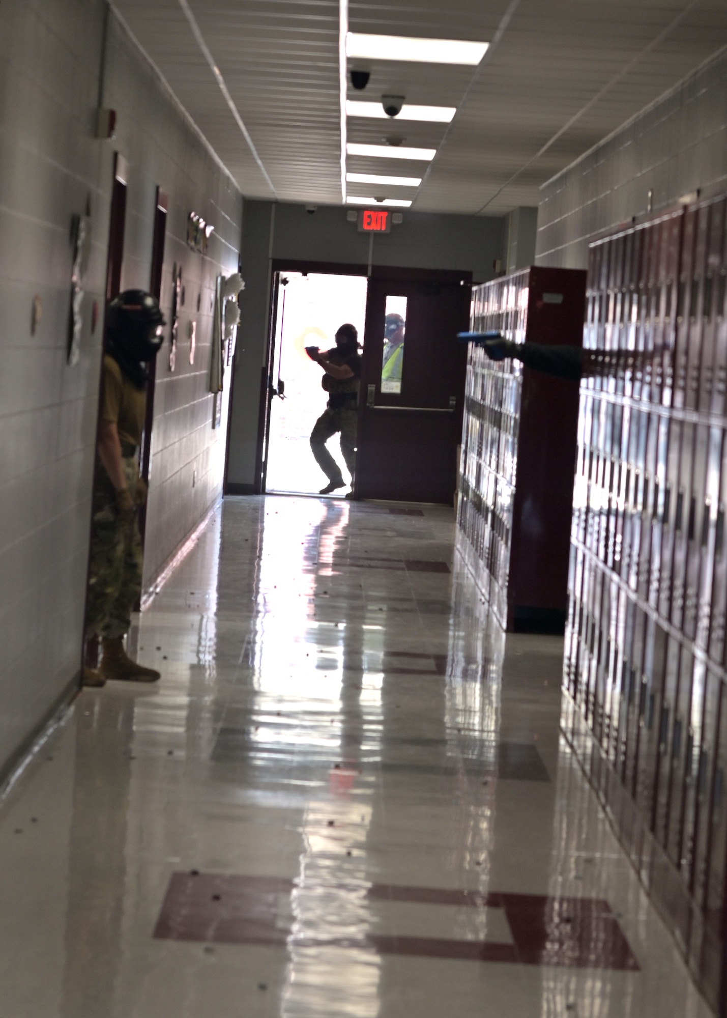 An ALERRT participant enters a school building to engage a simulated active shooter.