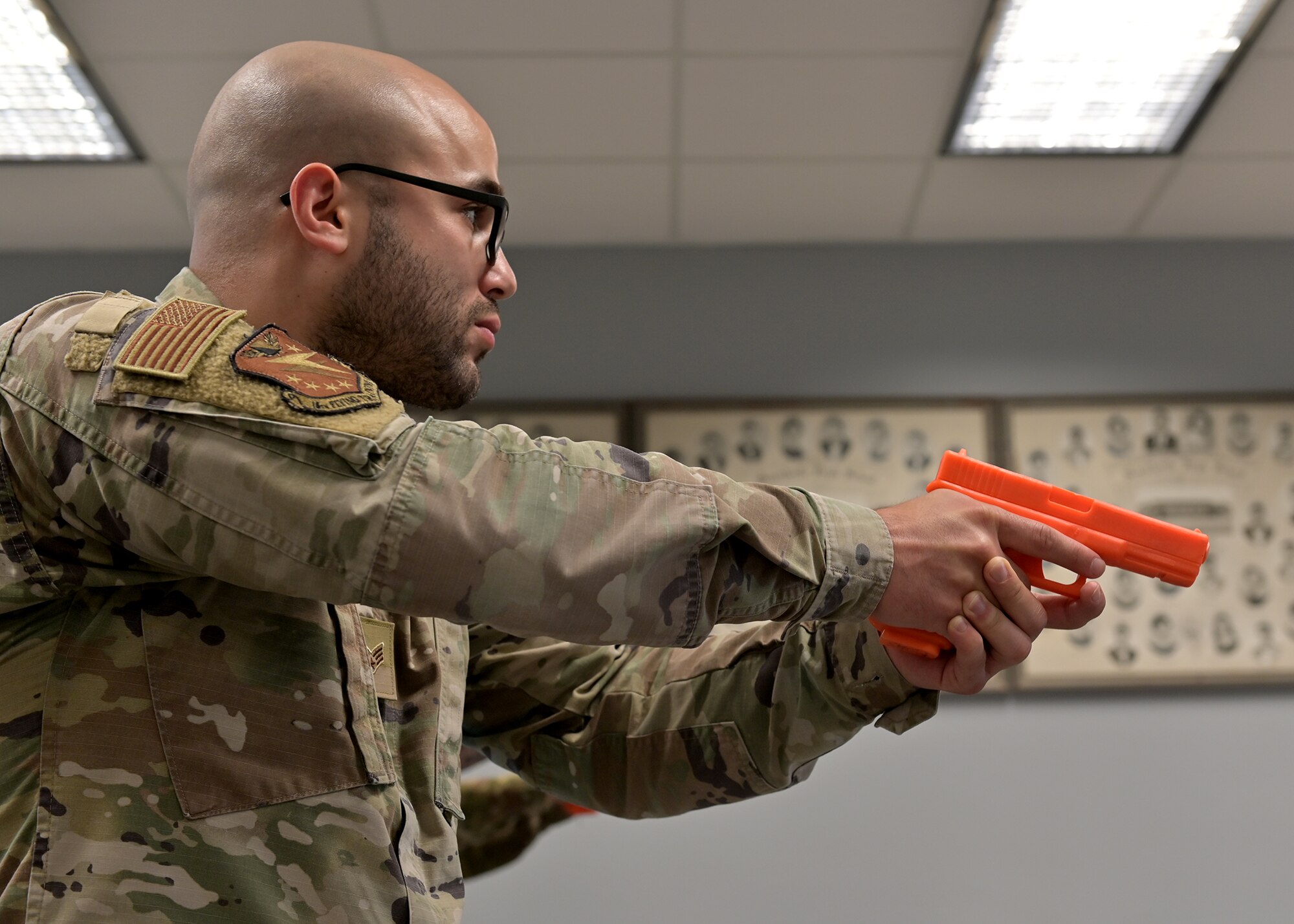 Senior Airman George Nur enters a classroom to engage a simulated active shooter.