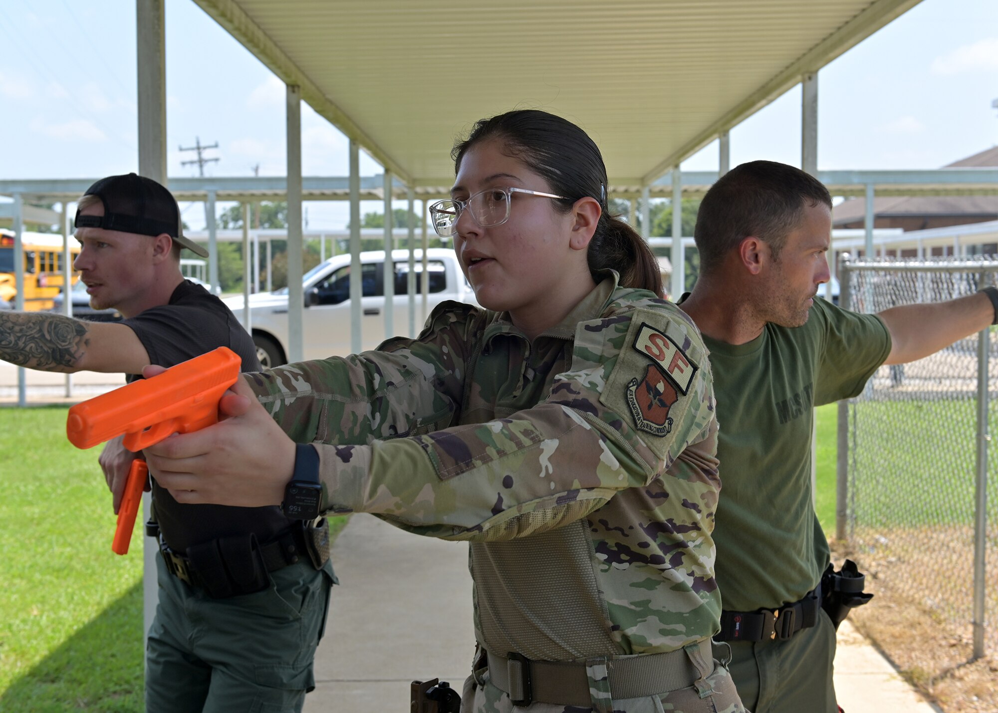 Airman Leidy Zarate, 14th Security Forces Patrolman, approaches the main entrance of the Smithville High School facility.