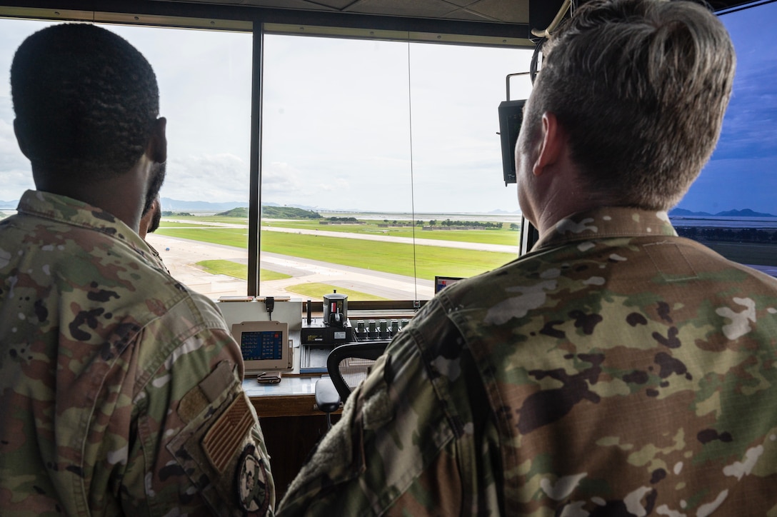 Chief Master Sgt. Jeremiah W. Ross and Master Sgt. Byron Wilkins observe flight line construction progress from the air traffic control tower during Ross’ immersion visit at Kunsan Air Base