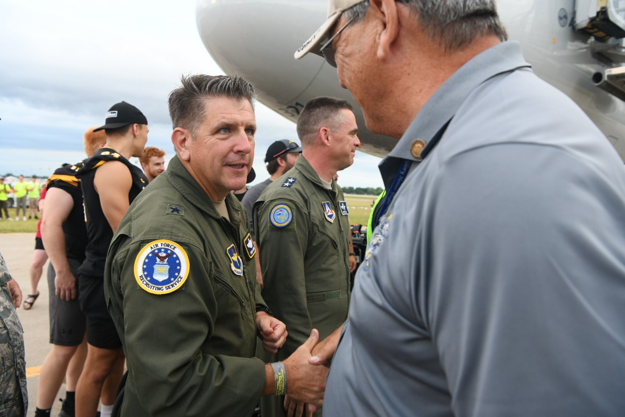Brig. Gen. Chris Amrhein, Air Force Recruiting Service commander, welcomes home Vietnam veterans, who were part of the honor flight, arriving back from a D.C. trip to AirVenture 2023 in Oshkosh, Wisconsin, July 28.