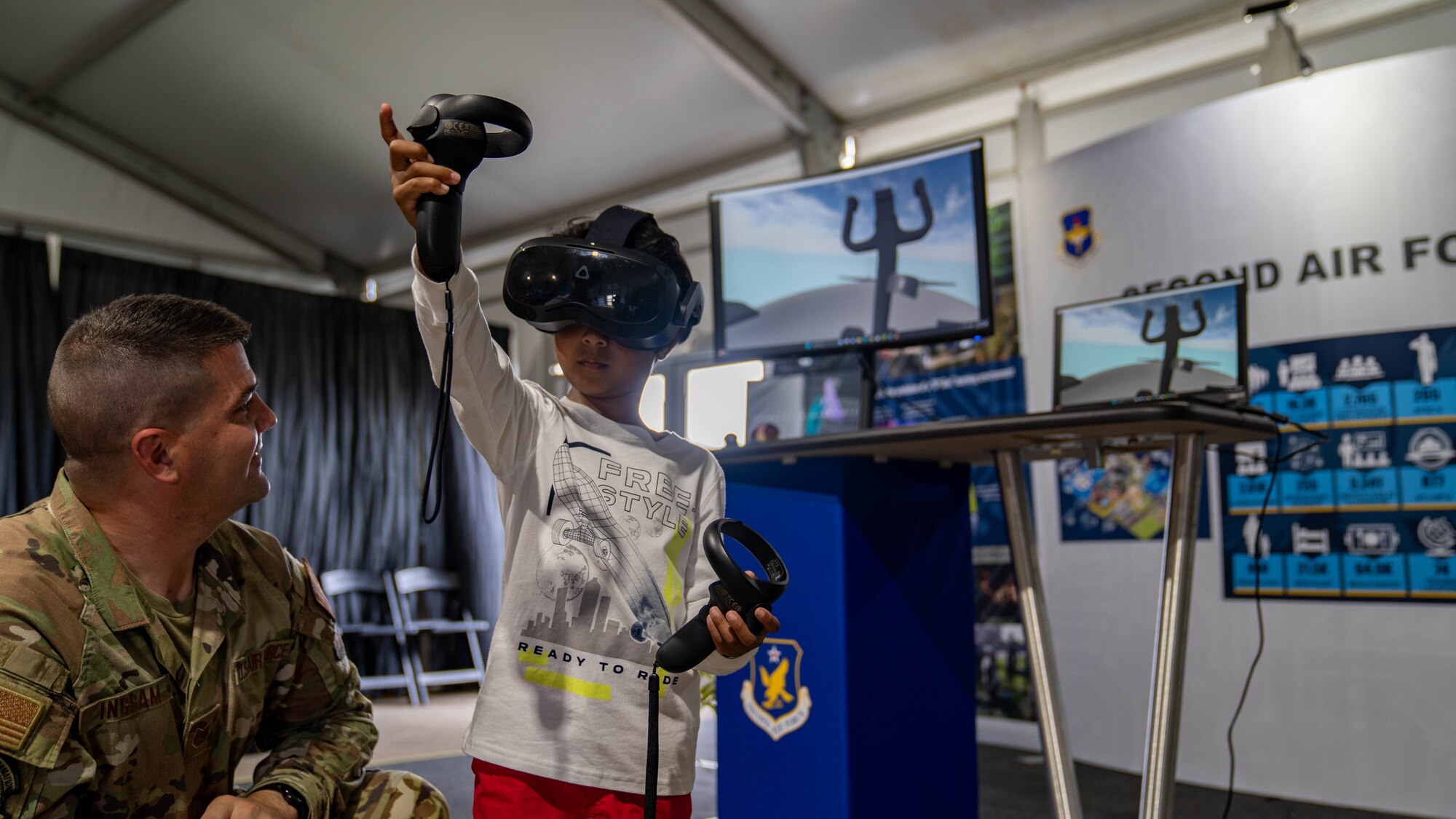 Tech. Sgt. Kyle Ingram, 82nd Training Wing learning engineer, displays virtual reality crew chief training at Experimental Aircraft Association Oshkosh AirVenture in Oshkosh, Wisconsin, July 27.