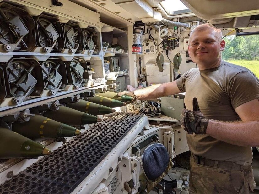 An unidentified Soldier with the 2nd Battalion, 138th Field Artillery, gives a thumbs up after loading ammunition into the M992 ammunition supply vehicle during the first stage of the Top Gun competition at Fort Chaffee, Arkansas, June 28, 2023.