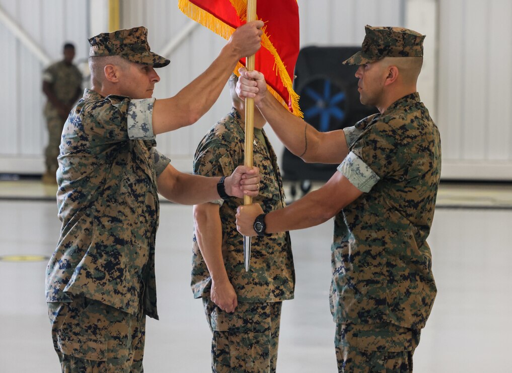 U.S. Marine Corps Col. Christopher L. Bopp, outgoing commanding officer for Marine Corps Base (MCB) Camp Blaz, left, receives the unit colors from Sgt. Maj. Daniel Soto, senior enlisted leader for MCB Camp Blaz, right, during a change of command ceremony at Andersen Air Force Base, Guam, July 10, 2023. Bopp relinquished command of Camp Blaz to Col. Ernest Govea after serving as the commanding officer since May of 2021. The change of command ceremony is an honored tradition, which signifies the transfer of command responsibility from one commander to another. (U.S. Marine Corps photo by Lance Cpl. Garrett Gillespie)