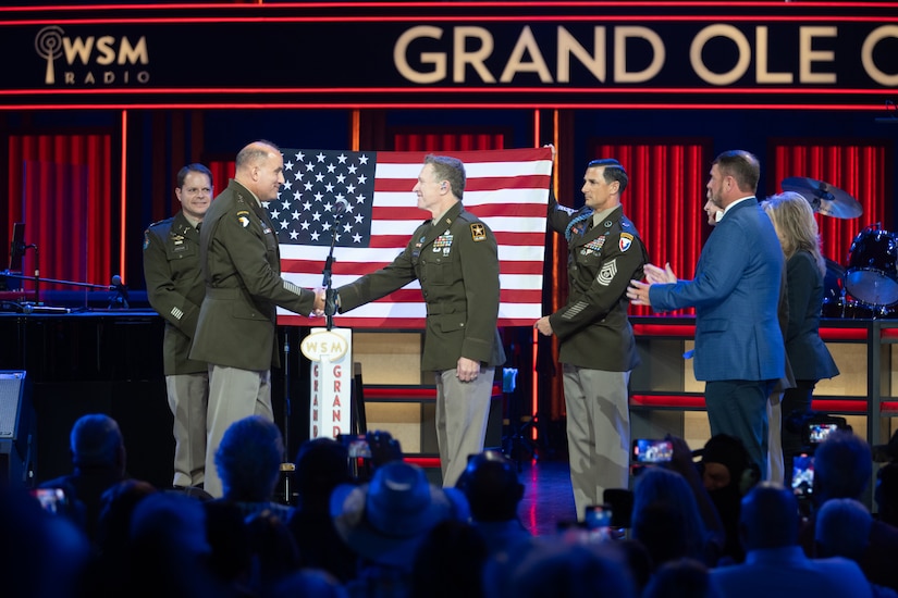 man wearing army uniform on stage