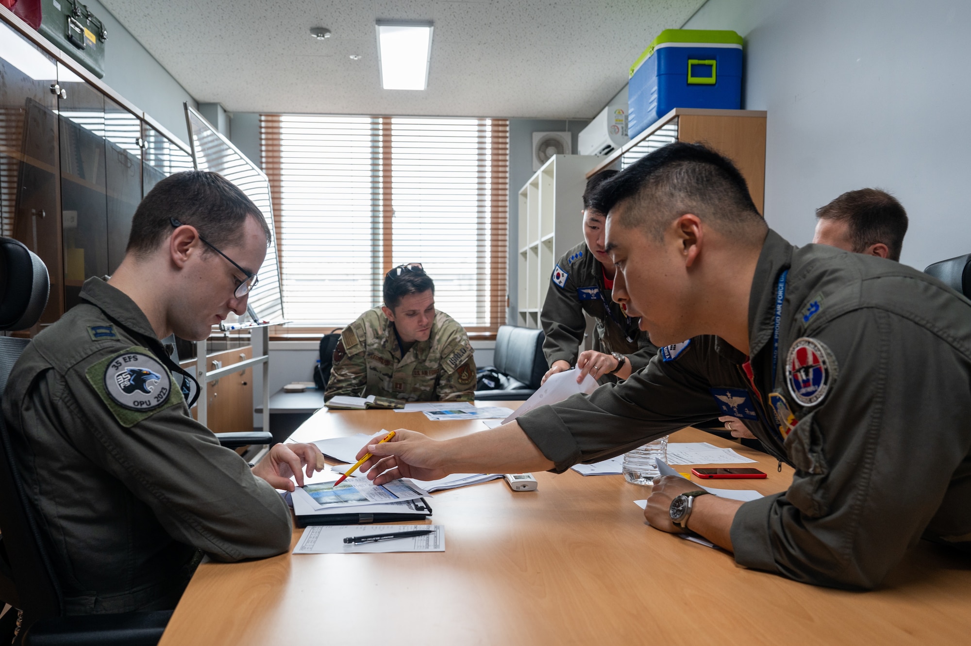 Republic of Korea Air Force Maj. Choi Sun Ltya details event plans with U.S. Air Force Capt. David Lee U.S.-ROK buddy squadron event at Cheongju Air Base