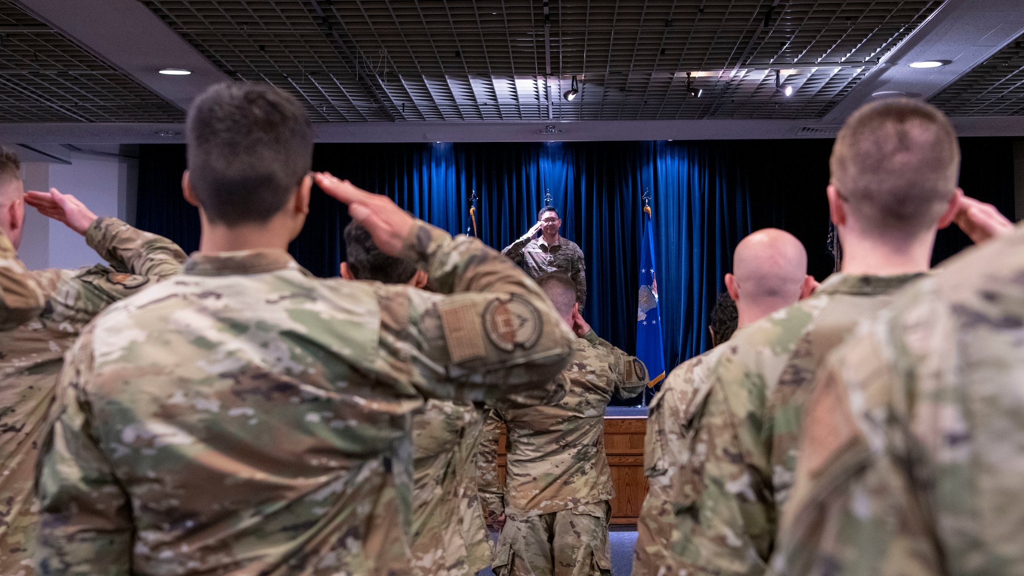 Military members salute a military member