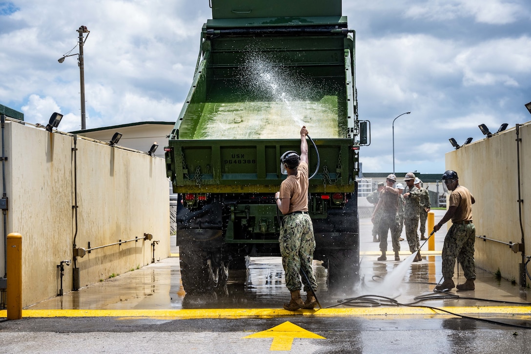 Sailors, assigned to Naval Mobile Construction Battalion (NMCB) 3, wash Civil Engineer Support Equipment during a Mount Out Exercise, onboard Camp Shields, Okinawa, July 19th.