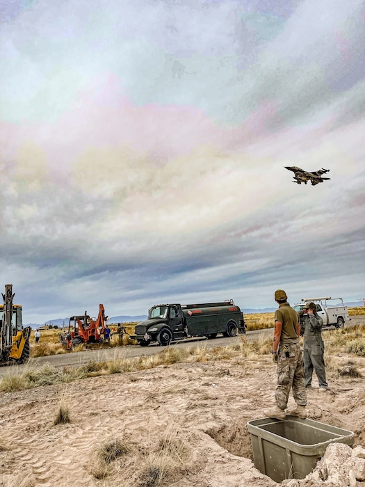 85th Engineering Installation Squadron Airmen stand by while an aircraft passes.