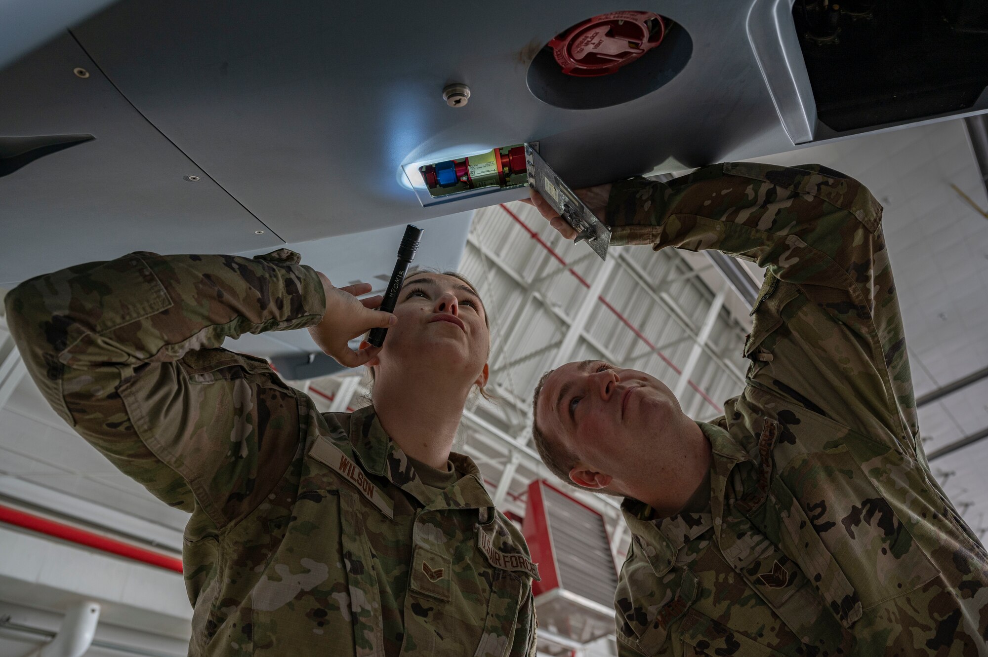 U.S. Air Force Senior Airman Morgan Wilson, 174th Attack Wing crew chief, left, and U.S. Air Force Tech. Sgt. Mathew Main, 491st Attack Squadron crew chief, conduct an inspection of an MQ-9 Reaper at Hancock Field Air National Guard Base, New York, June 29, 2023. The 491st ATKS is composed of both active duty and Air National Guard personnel responsible for training student pilots and sensor operators how to operate an MQ-9 Reaper. (U.S. Air Force photo by Airman 1st Class Isaiah Pedrazzini)
