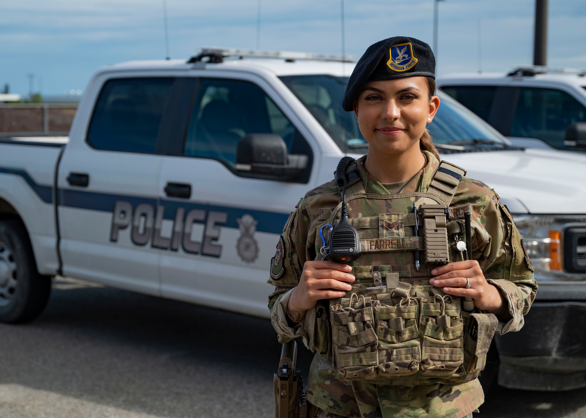 Senior Airman Precious Farrell, a 354th Security Forces Squadron alarm monitor, stands in front of a police vehicle July 11, 2023, on Eielson Air Force Base, Alaska. Farrell acted as the dispatcher for a family threatened by an aggressive moose and her calf. (U.S. Air Force photo by Staff Sgt. Beaux Hebert)