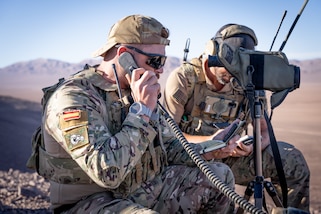 A Joint Terminal Attack Controller from Spain looks through binoculars on a range outside Antofagasta, Chile, during exercise Southern Star 23, July 24, 2023.