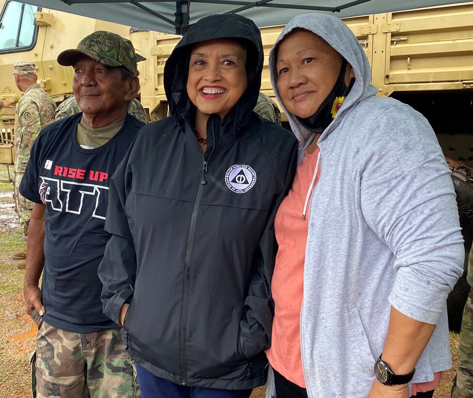 Guam Governor Lou Leon Guerrero poses with RISEUP roof recipients Fely and Gerald Baza to commemorate the completion of the final metal roof installation by Task Force RISEUP in Dededo, Guam in response to Typhoon Mawar July 27. The U.S. Department of Defense and the U.S. Army Corps of Engineers, in coordination with the Federal Emergency Management Agency and the U.S. Territory of Guam, launched the Roofing Installation Support Emergency Utilization Program, or RISEUP, to help temporarily repair metal roofs damaged by Typhoon Mawar, which made landfall May 24.