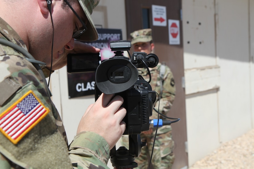 Spc. Jacob Hoffman, a public affairs broadcast specialist with the 109th Mobile Public Affairs Detachment, 213th Regional Support Group, Pennsylvania National Guard checks audio levels Aug. 6 at the National Training Center, Fort Irwin, Ca.