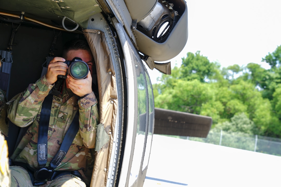 U.S. Army Pfc. David Thomson, a mass communication specialist with the 109th Mobile Public Affairs Detachment, 213th Regional Support Group, Pennsylvania Army National Guard, snaps a few shots of a training exercise during his Annual Training at Ft. Indiantown Gap, PA. July 20, 2022.