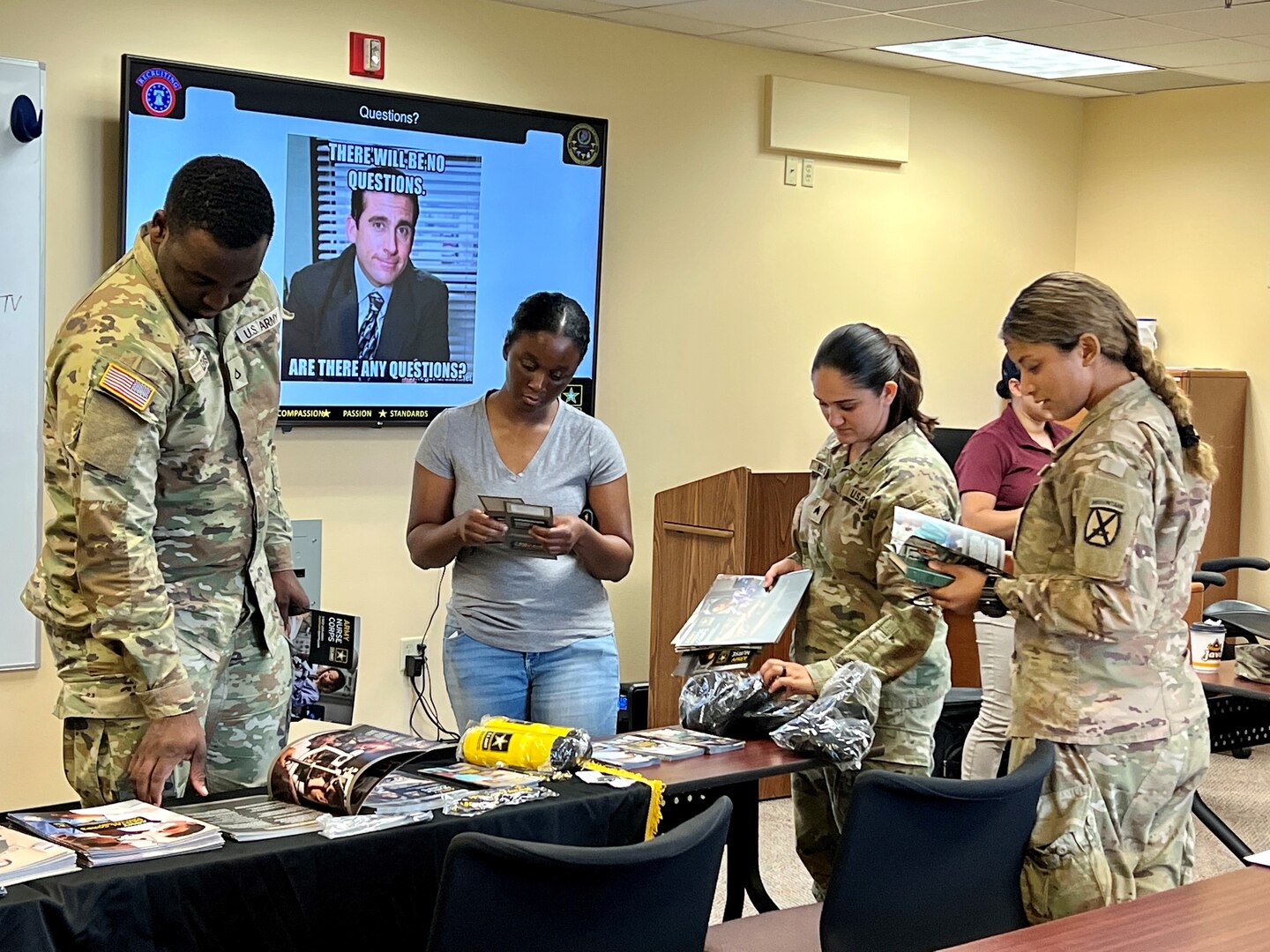 Group of people standing around a recruiting table