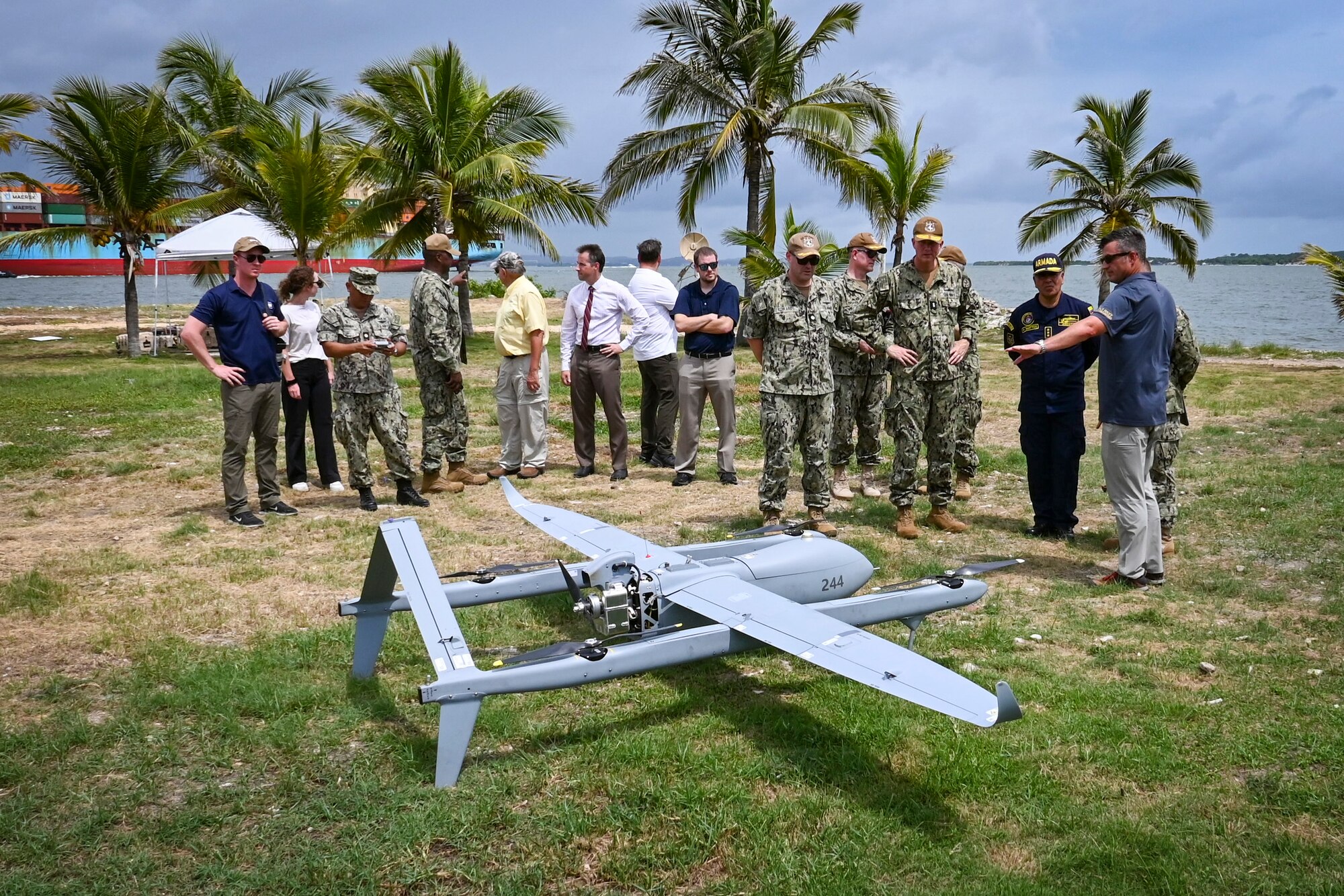 Photos of NITAS members from Colombia and the Republic of Korea discuss the Aerosonde MK4.7 Hybrid Quad unmanned aerial vehicle during demonstration of at the Club Naval Castillogrande during UNITAS LXIV, July 16, 2023.
