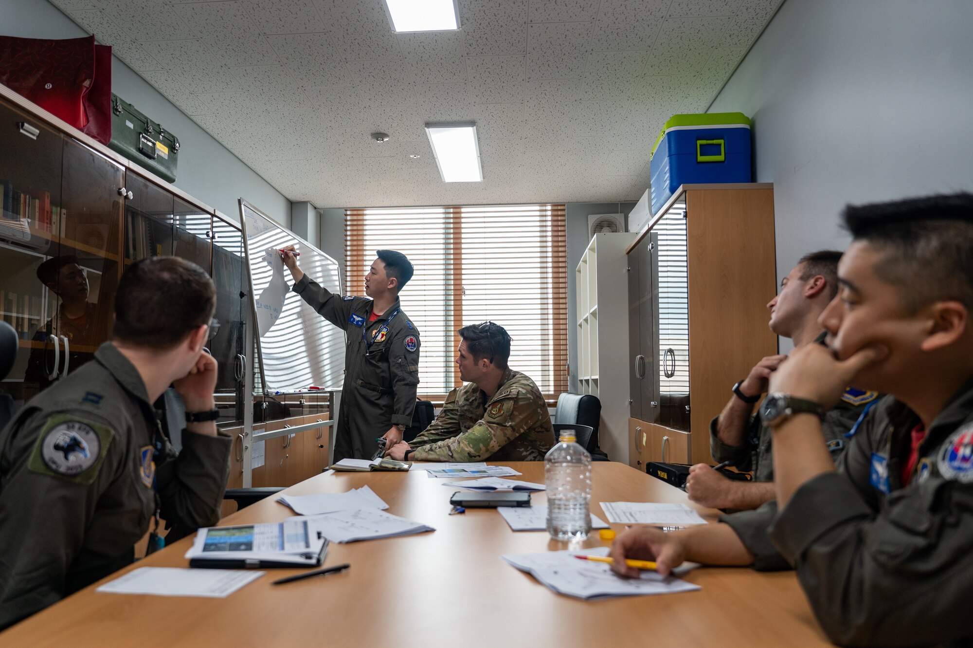 Republic of Korea Air Force Capt. Hyun Yong Sim briefs upcoming flight plans for the U.S.-ROK buddy squadron event at Cheonju Air Base