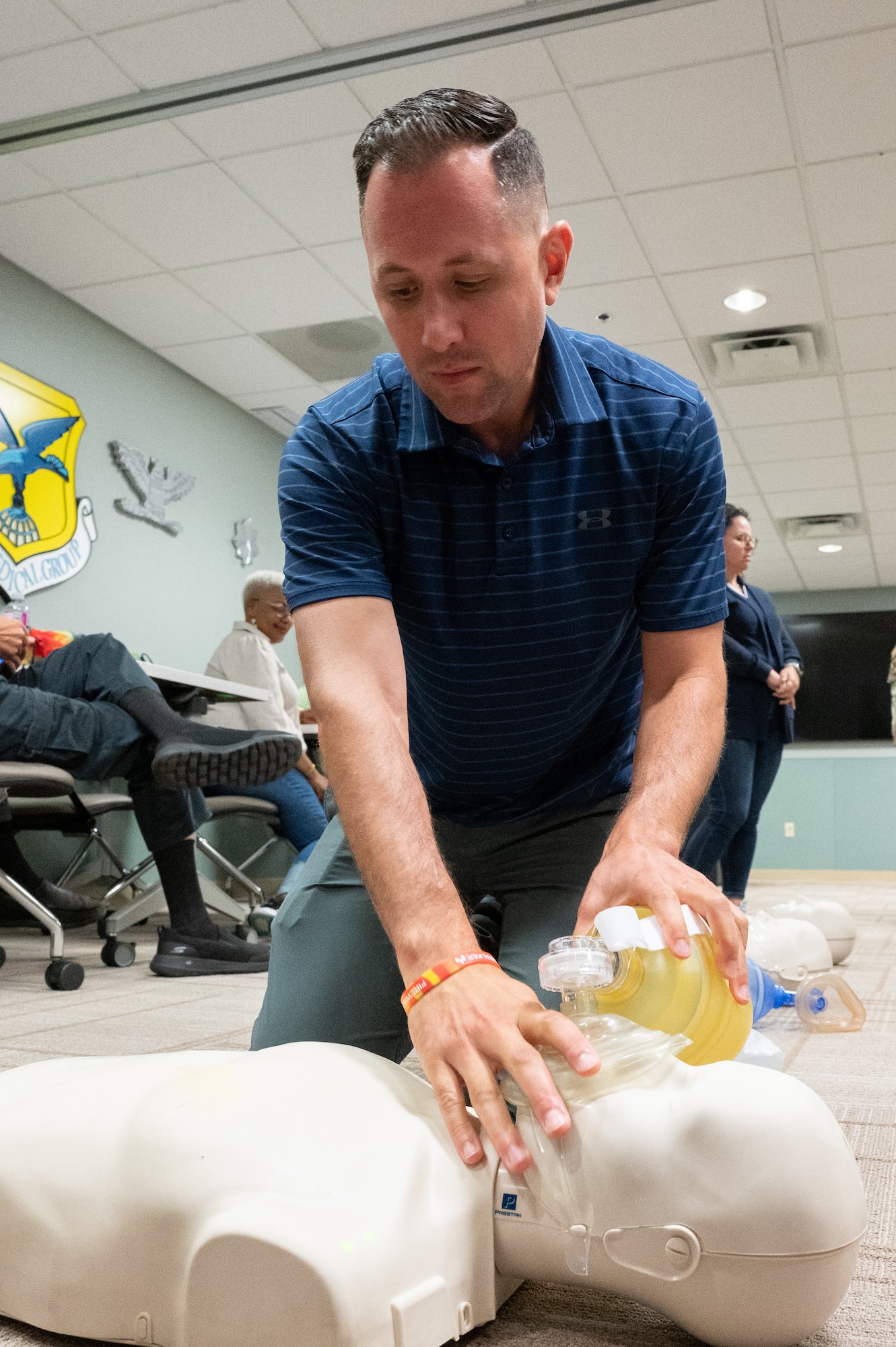 Robby Sheehan, 512th Airlift Wing honorary commander, practices CPR during a tour at Dover Air Force Base, Delaware, July 28, 2023. The honorary commanders toured various departments within the 436th Medical Group to familiarize them with their mission and capabilities. (U.S. Air Force photo by Mauricio Campino)