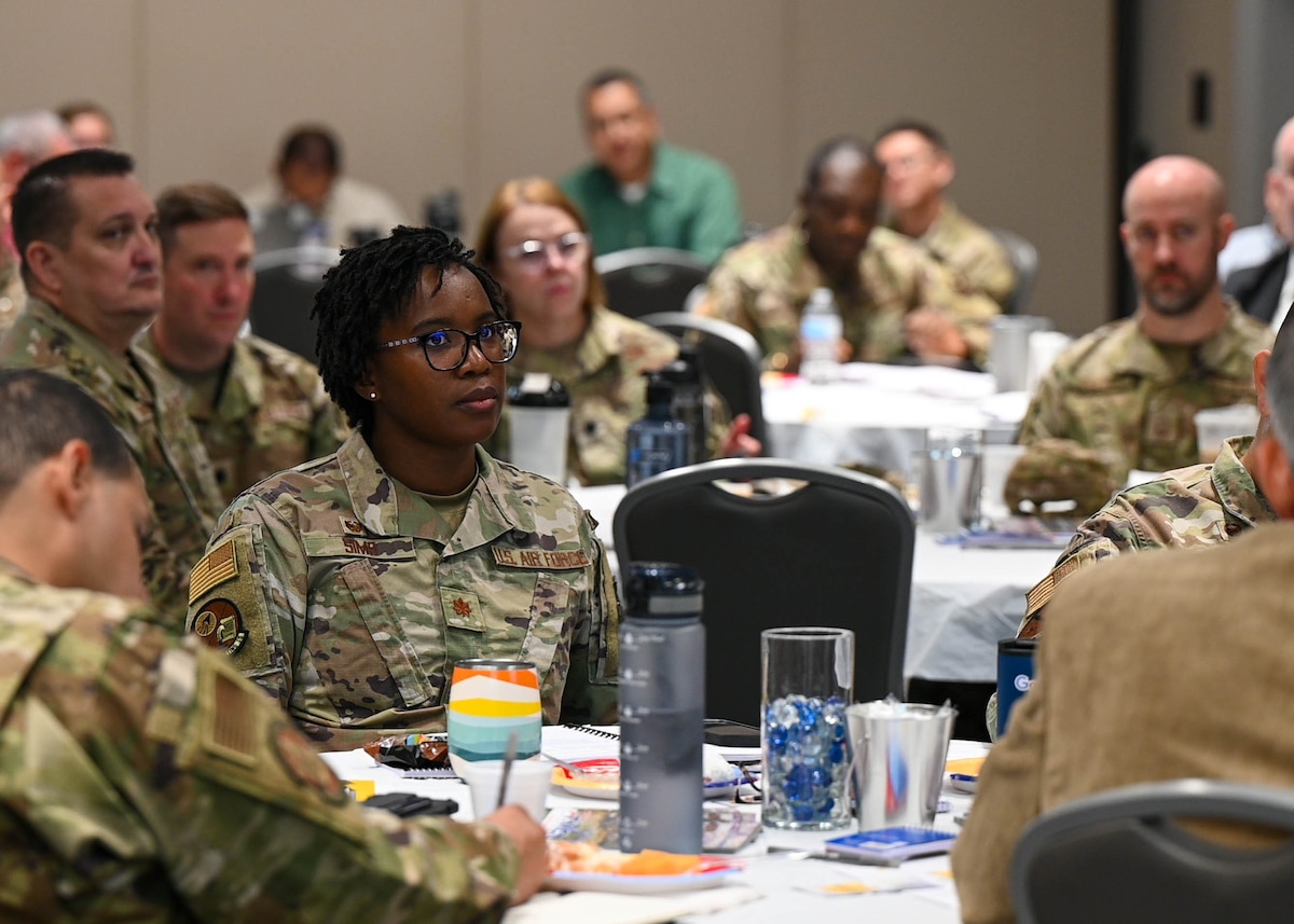 U.S. Air Force Maj. Anita Sims, 17th Contracting Squadron commander, listens during the Senior Leader Summit at the Powel Event Center, Goodfellow Air Force Base, Texas, July 26, 2023. The event provided senior leaders with a large networking opportunity and inducted new Raiders into the 17th TRW way of life. (U.S. Air Force Photo by Airman 1st Class Zach Heimbuch)