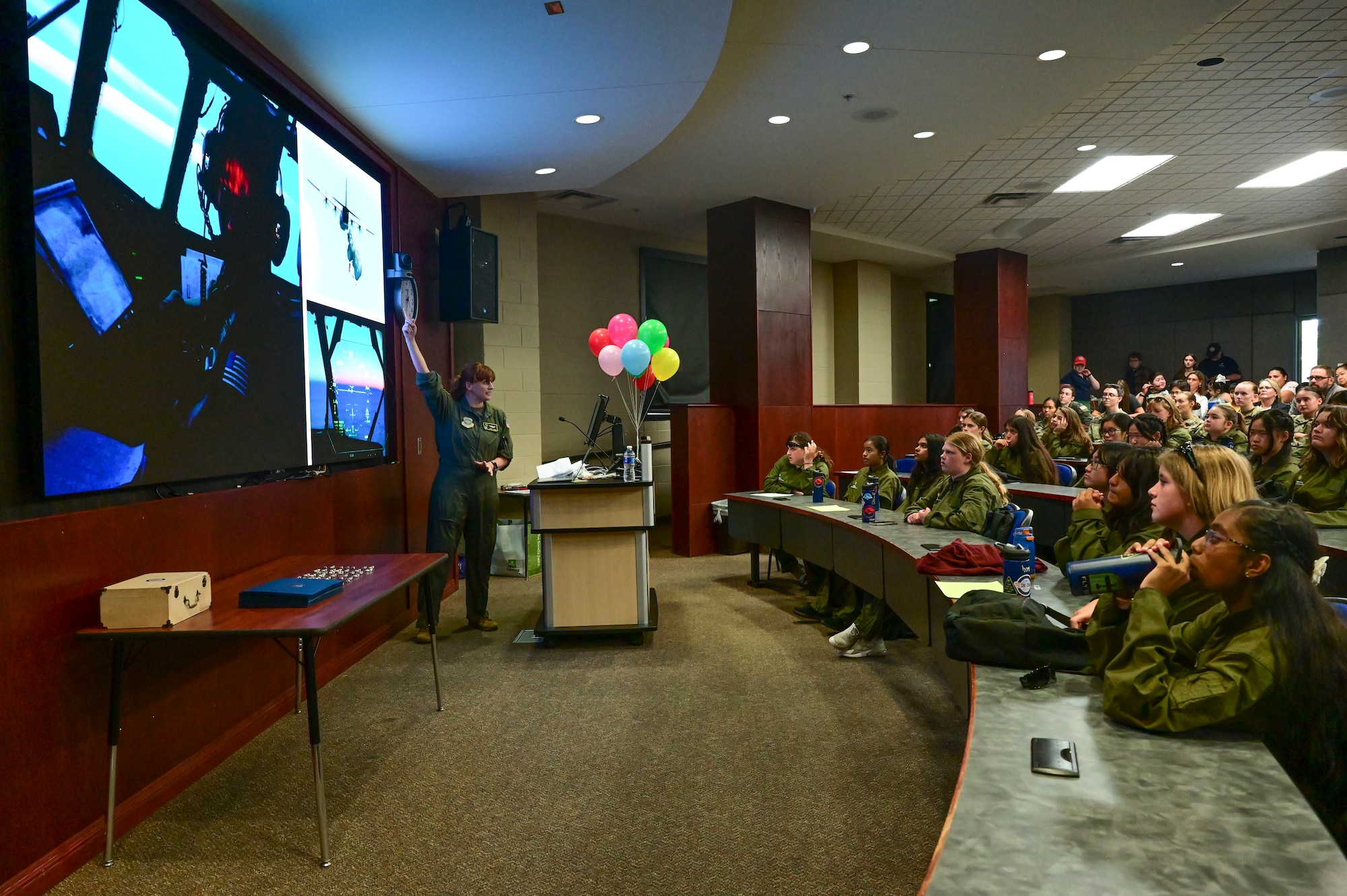 An Airman briefs a room of students.