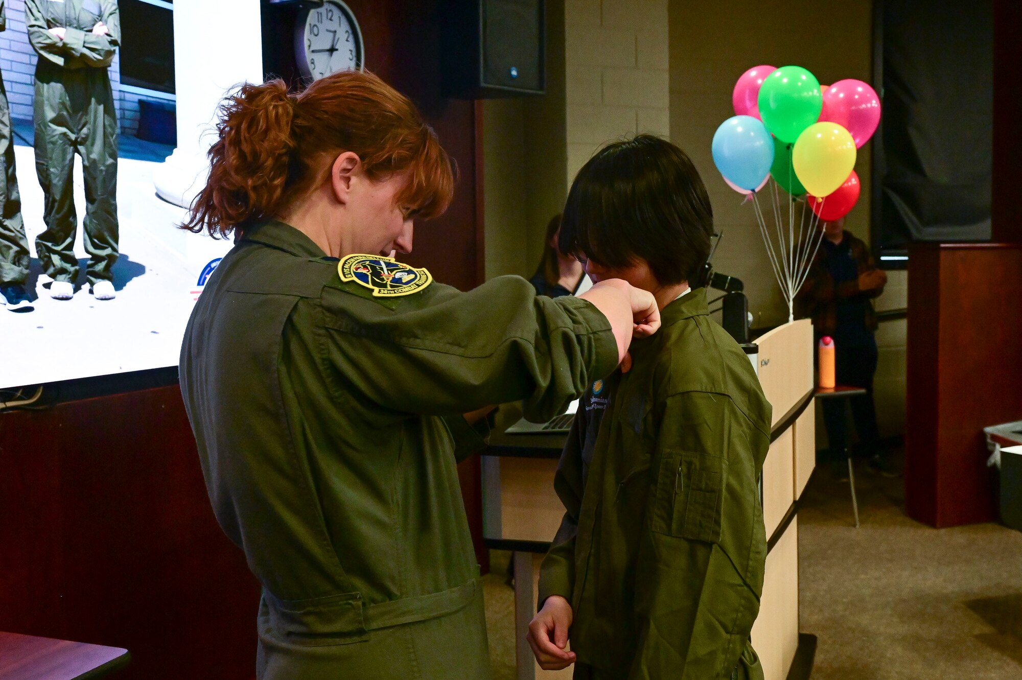 An Airman pins wings on a student.