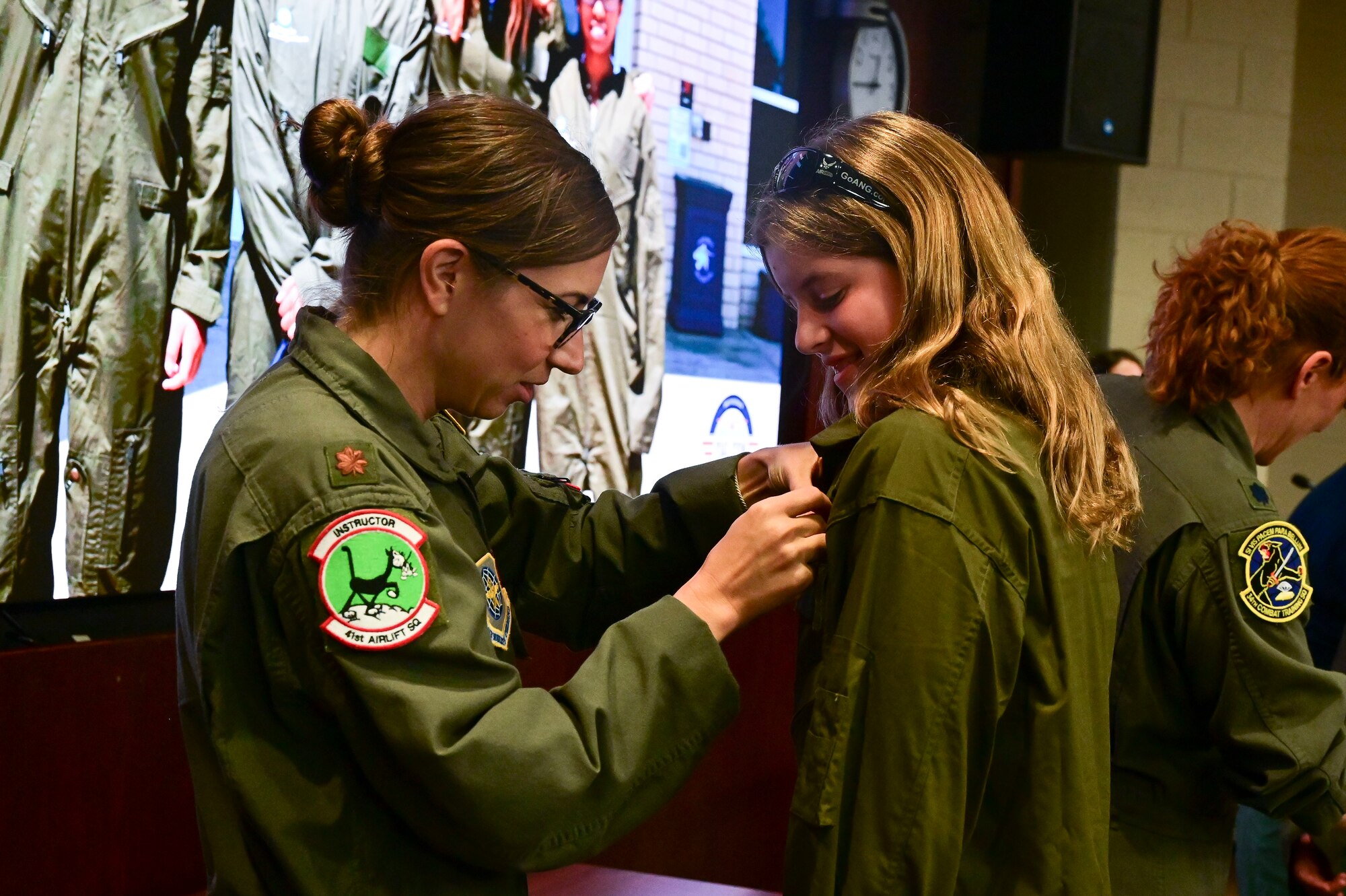 An Airman pins wings on a student.